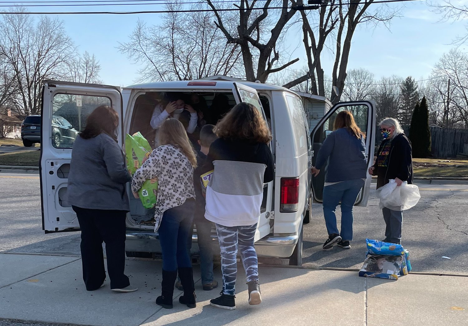 Hoover Elementary students load donated pet food into a van for Home for Friendless Animals. The school