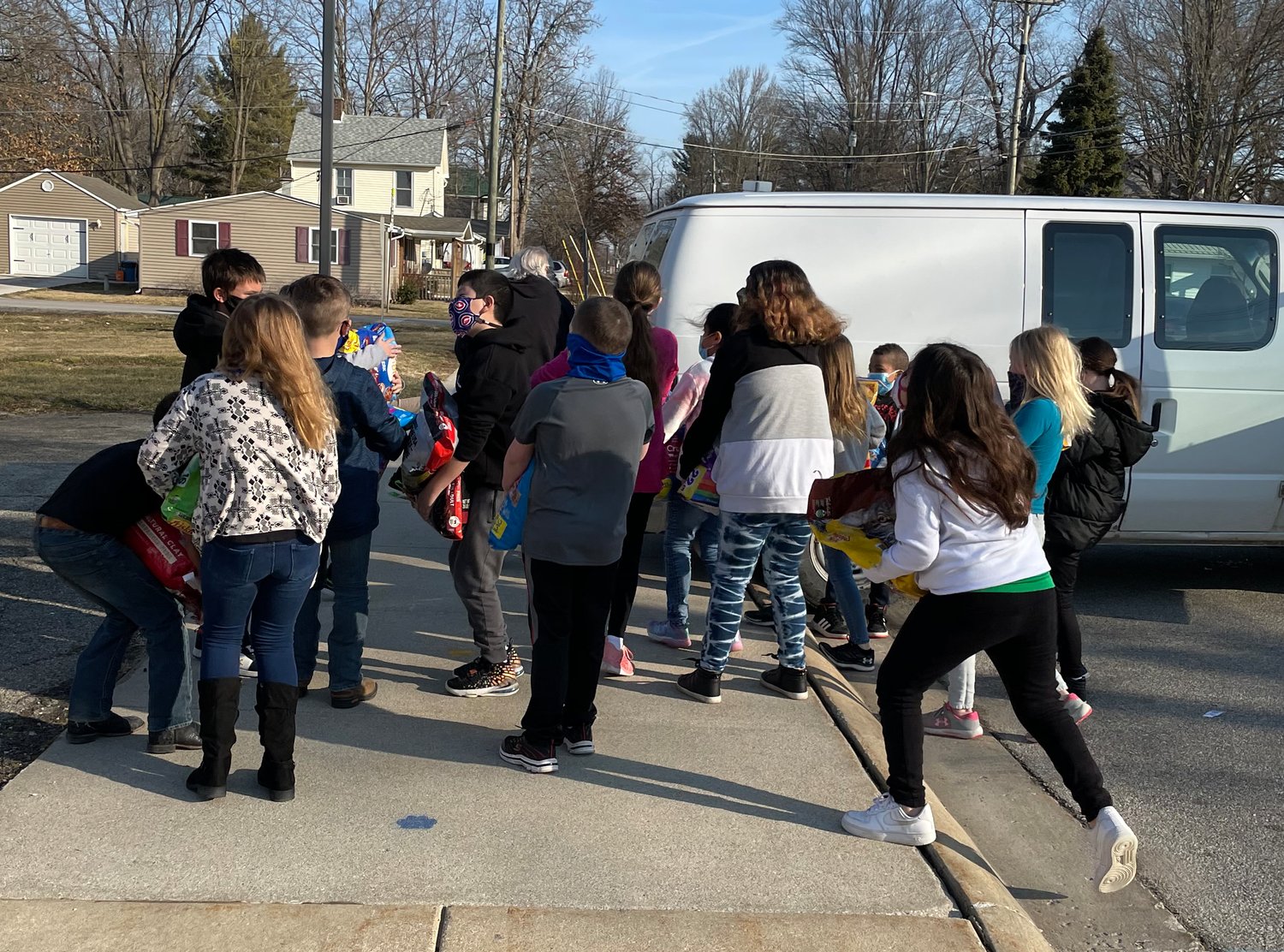Hoover Elementary students carry donated pet food to a van for the Animal Welfare League of Montgomery County and the Home for Friendless Animals.