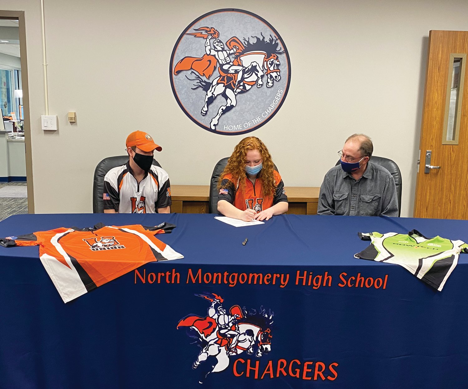 North Montgomery senior Ashley Coffing commits to Union College in Kentucky, where she will compete in archery and continue her education in pursuit of a nursing degree. PICTURED: Union College coach Cody Kirby, Ashley, and her Dad, Brian Coffing.