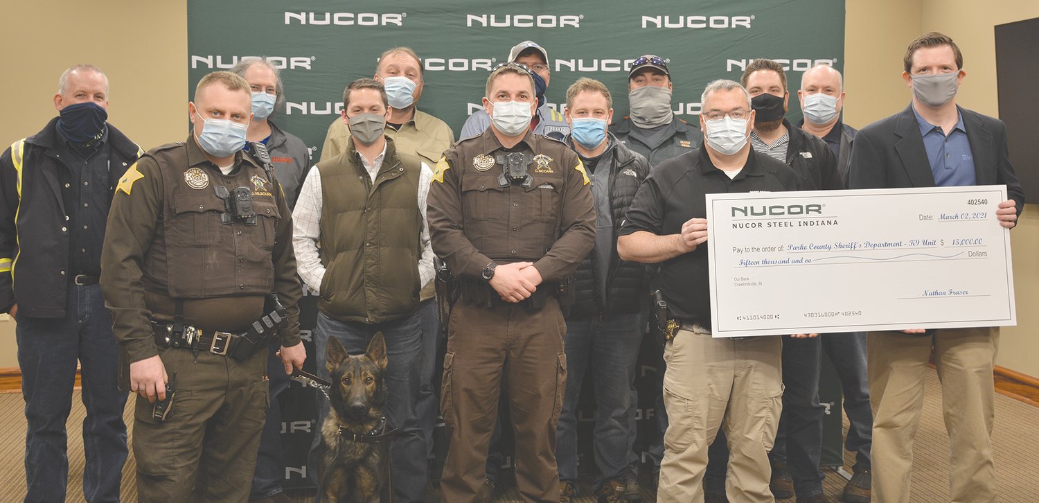 Nucor Steel made a $15,000 donation for the Parke County Sheriff’s Department to help financially with a K-9 Unit. Pictured are front row, K9 Deputy Josh Milbourn, K9 Kilo, K9 Deputy Chris McCann, Sheriff Justin Cole and Nathan Fraser; middle row, Drew Linder, Scott Shortridge and Eric Radtke; and back row, Phil Littell, Doug Brooks, Trevor Beers, Keith Shelton, Brandon Gurley and Ron Kessel.