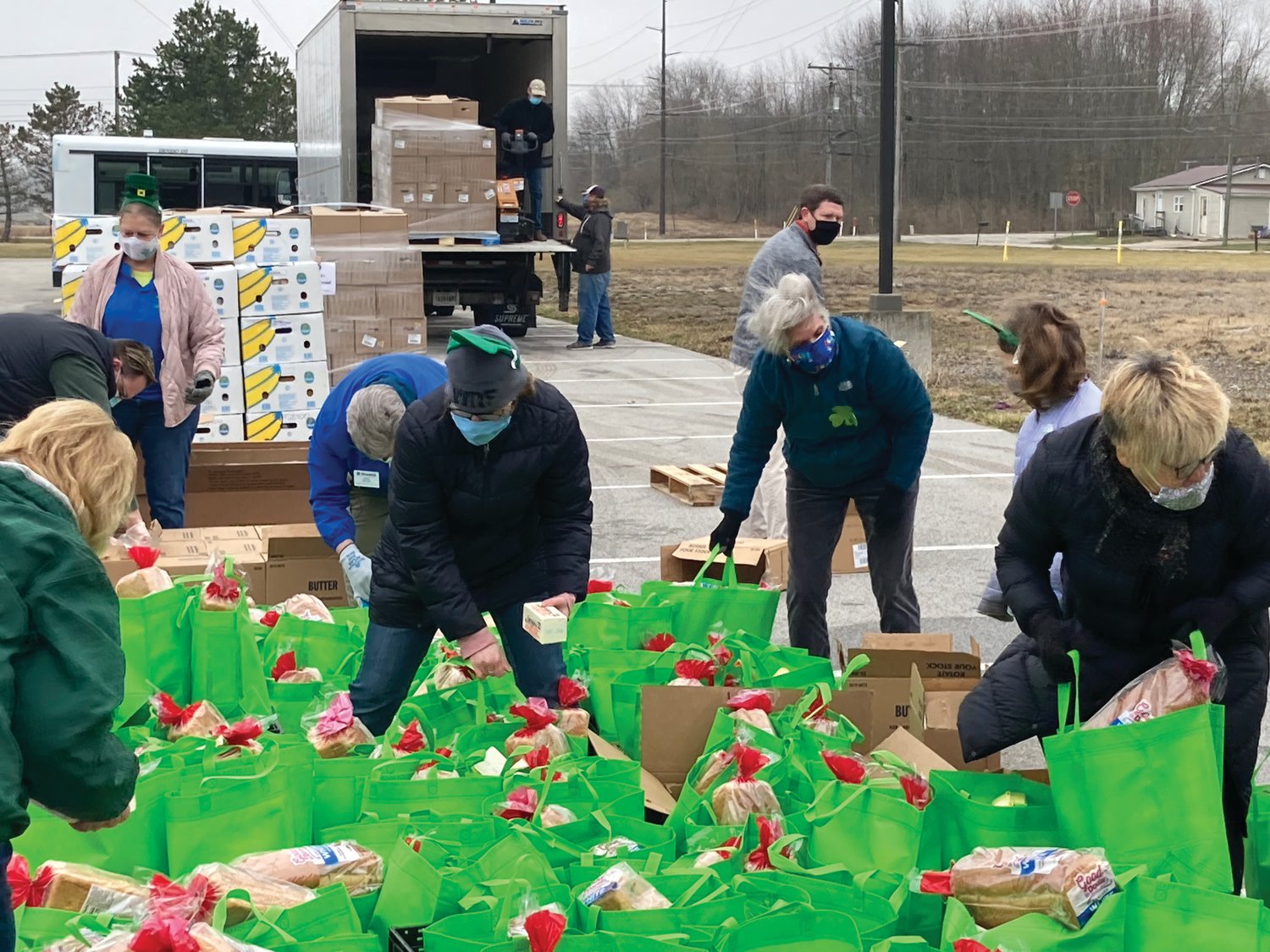 Montgomery County Youth Service Bureau employees pack food before a Food Finders Food Bank Mobile Food Pantry distribution at the Boys & Girls Club of Montgomery County on Wednesday.