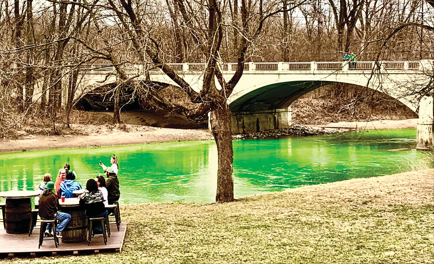 Creekside Lodge patrons dine next to Sugar Creek, which was dyed green Wednesday for St. Patrick