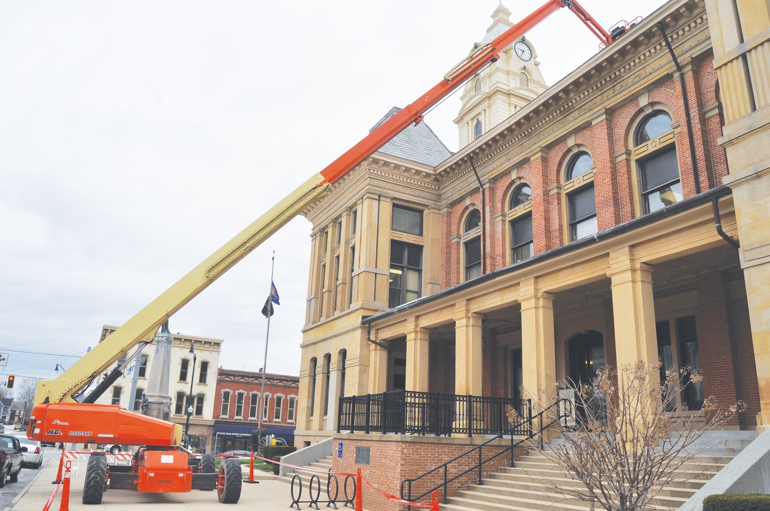 A crane touches the roof of the Montgomery County Courthouse Tuesday. Crews from South Bend-based Midland Engineering were hired to perform gutter repairs on the courthouse. The sidewalk was closed on the south side of the building during the repairs.