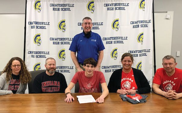 Crawfordsville senior Hunter Conrad committed to swim at Indiana Wesleyan. PICTURED L-R: Elizabeth Conrad, Chris Conrad, Hunter Conrad, Angie Farley, and Mike Farley. Back row: Crawfordsville swim coach Kevin Hedrick.