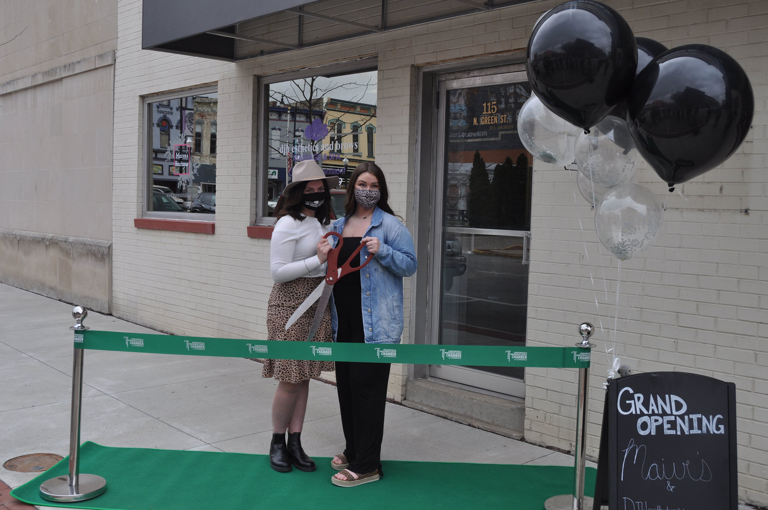 Lilly Wallace, left, and Demi Haas prepare to cut the ribbon of their businesses Maive’s Boutique and djh esthetics and brows at the Weemickle Building in downtown Crawfordsville.