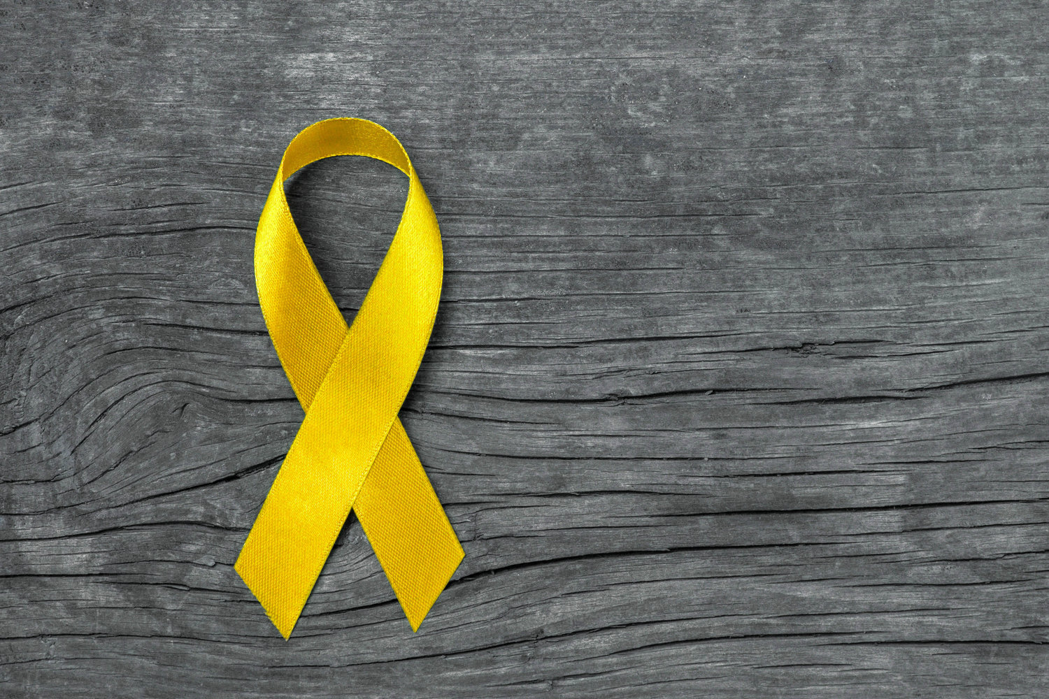 The yellow ribbon represents suicide awareness and prevention and survivors.