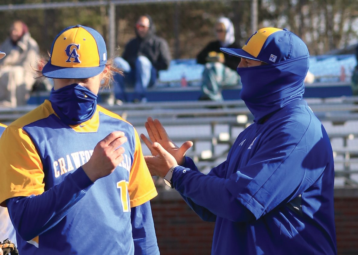 First-year Crawfordsville baseball coach Brett Motz encourages his young team on Friday night in the Athenians season opener against Riverton Parke.