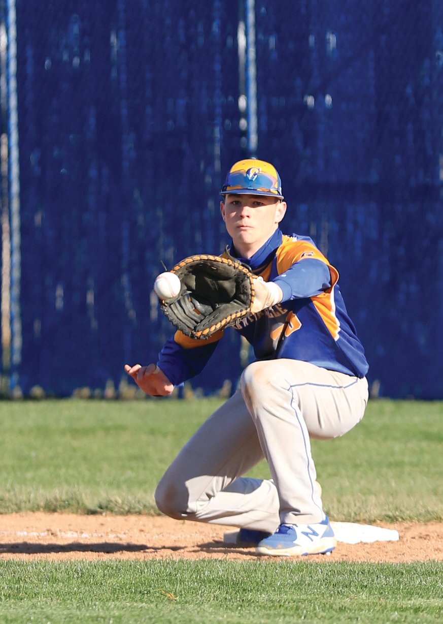 Crawfordsville sophomore Kaiden Underwood snags a ball at first-base for the Athenians.