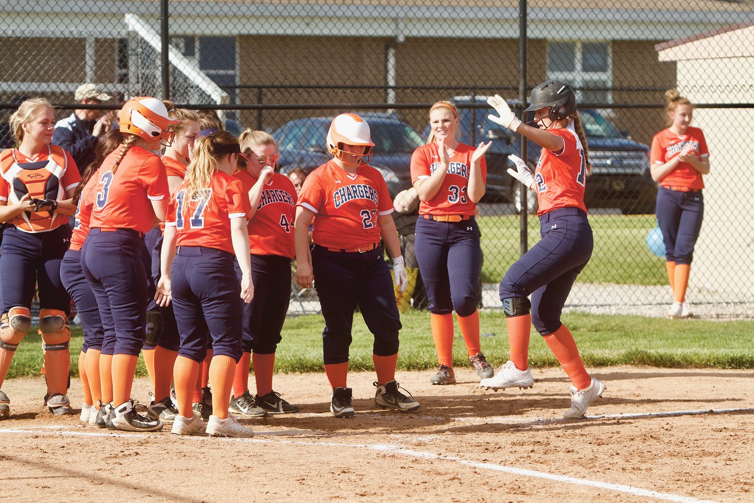 The Chargers celebrate after a Makinze Rominger's home run.