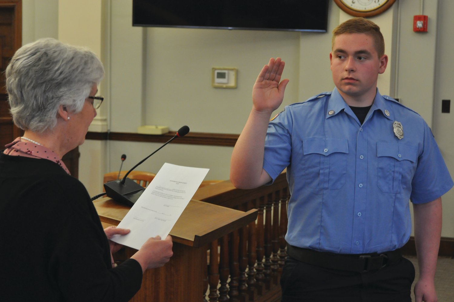 Gavin Waddell takes the oath as a Crawfordsville firefighter/EMT from Clerk-Treasurer Terri Gadd in the City Building on Wednesday.