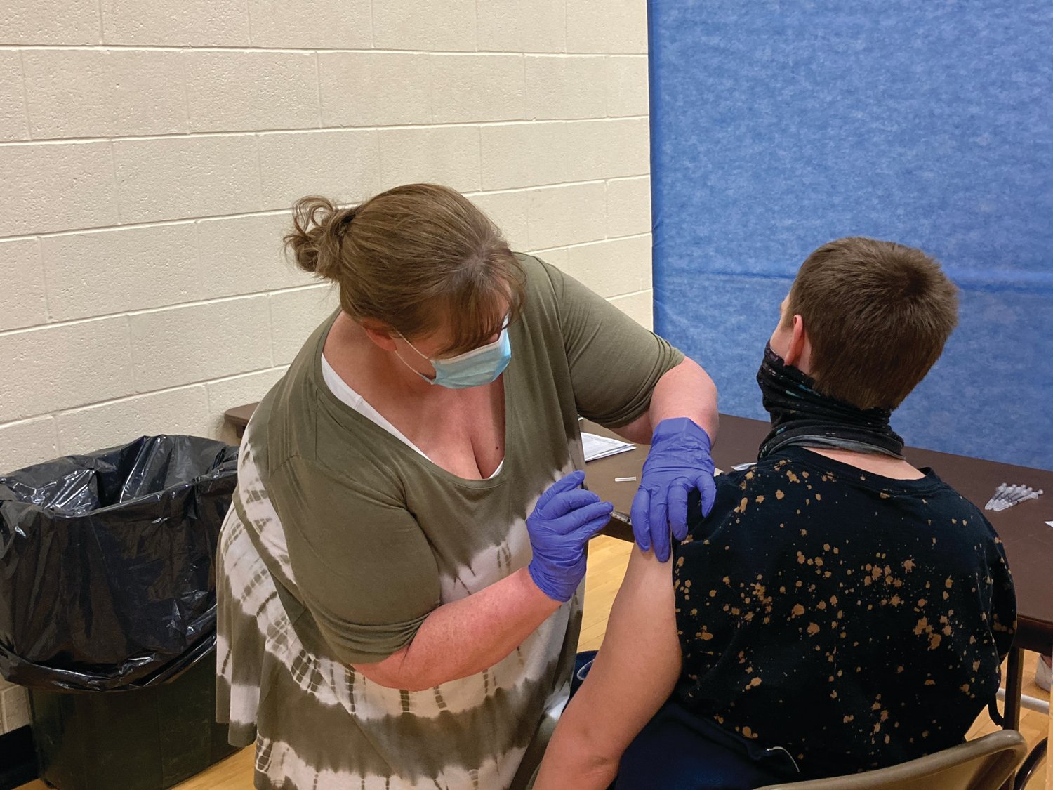 Crawfordsville Middle School nurse Amy Bales administers a COVID-19 vaccine to a Crawfordsville High School student at the high school Friday. The Montgomery County Health Department and the Community Paramedicine Program partnered to vaccinate high school students 16 and older. Students at Southmont and North Montgomery also received their shots Friday.