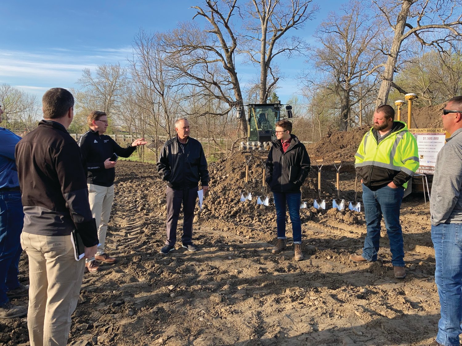 Montgomery County Administrator Tom Klein, third from left, talks with county government officials and representatives from United Consulting and Milestone Contractors before a groundbreaking ceremony at the C.R. 100W construction site Friday.