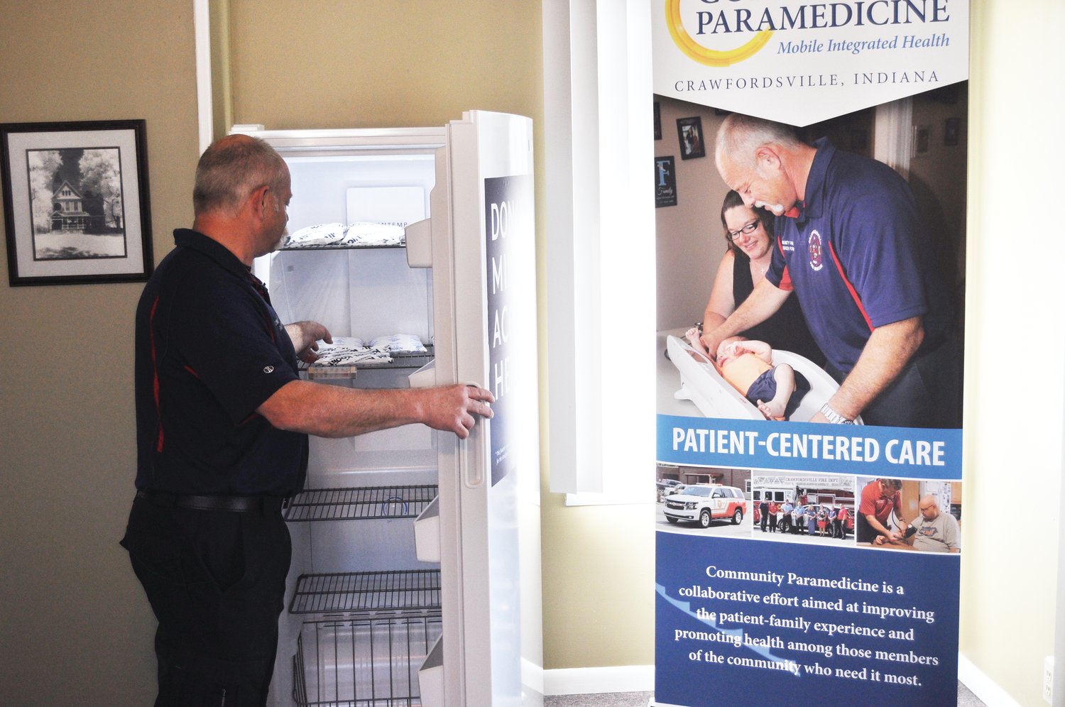 Darren Forman, community paramedic and coordinator of the Project Swaddle program, opens a freezer Monday that will store donor breastmilk at the Crawfordsville Fire Department Paramedicine Center. The department partnered with nonprofit The Milk Bank to provide a dropoff site for donor mothers.