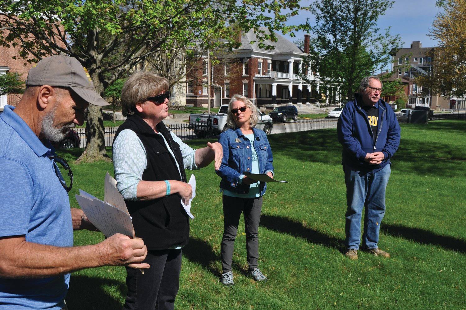 Sue Lucas, program manager of Crawfordsville Main Street, speaks during an Arbor Day tree planting ceremony as Mark Davidson, Belinda Kiger and Jeff Bickel look on at the Lane Place Friday. Main Street planted a tree in memory of Bickel