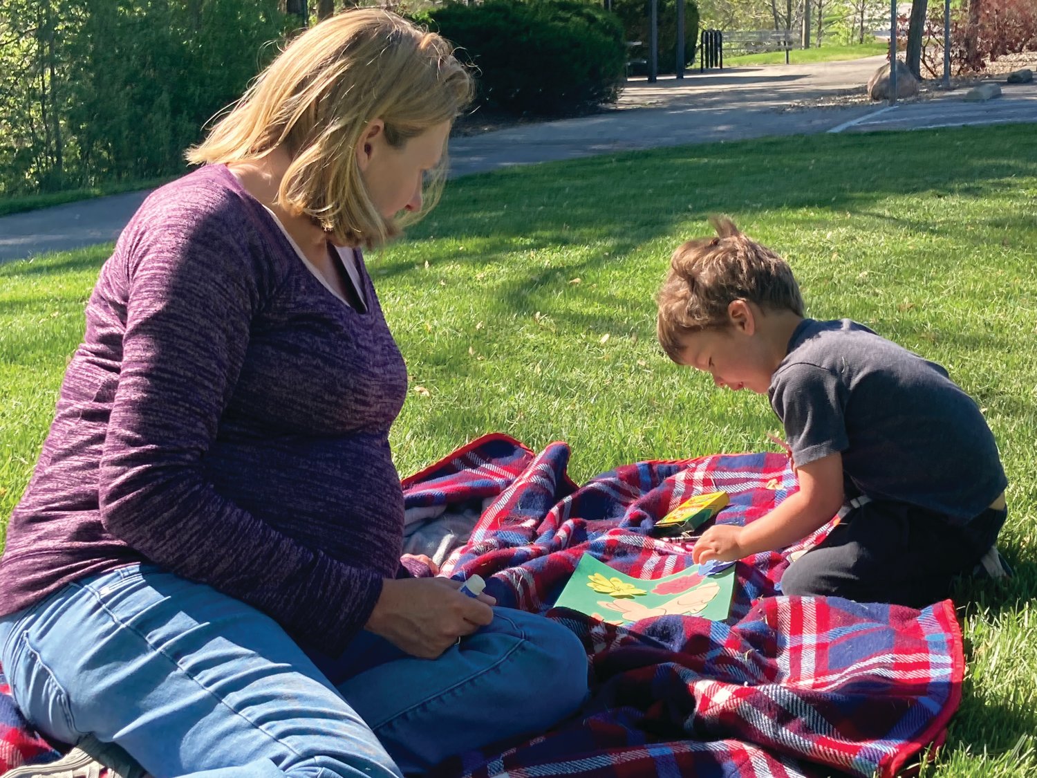Leo Jay, 3, works on a craft with his mother,  Sarah, during the Crawfordsville District Public Library Story Time at the Sugar Creek Trail on Wednesday.