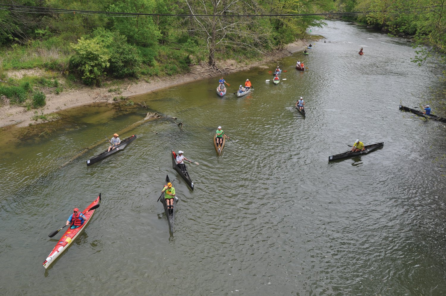 Paddlers leave the Old Coke Plant launch site in May 2021 for the Friends of Sugar Creek Canoe Race.