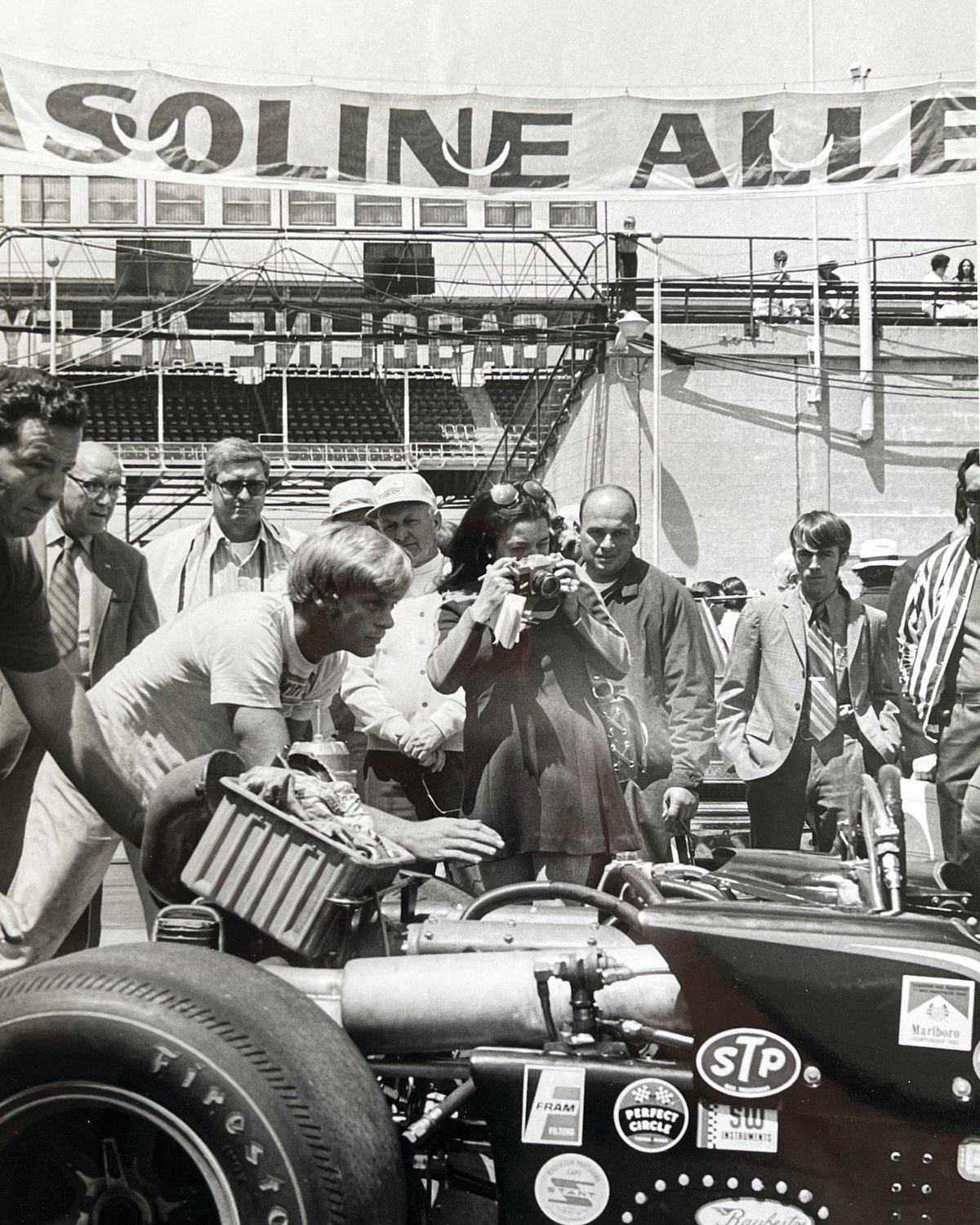 Bettie Cadou snags a picture of an Indy Car in the pits at Indianapolis Motor Speedway in 1971 after becoming the first female journalist to gain access to Gasoline Alley.