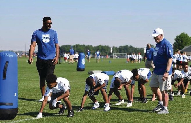 Crawfordsville’s Steve House, right, joined Wabash assistant football coach Olmy Olstead, not pictured, with Indianapolis Colts defensive end DeForest Buckner, left, at a youth camp at Grand Park in Westfield.