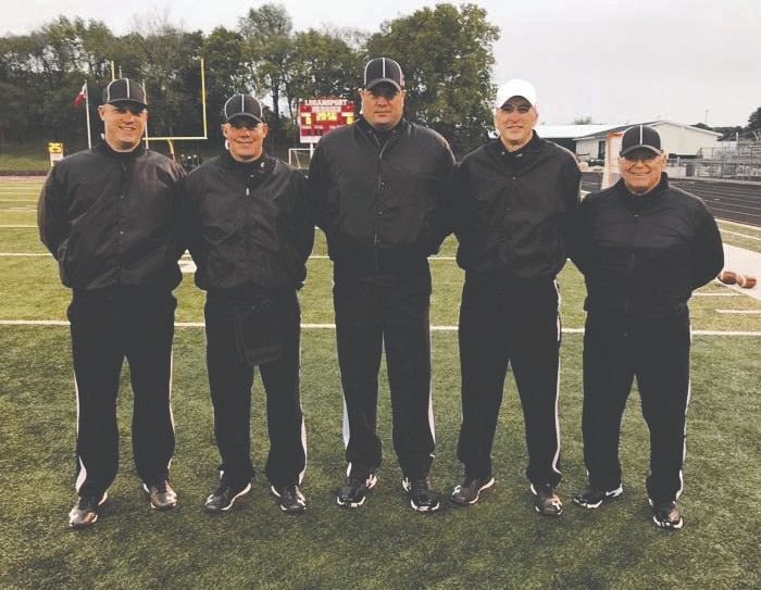 Mark Maxwell, right, poses with his officiating crew of Steve Hoffman, Jeff Gilstrap, Chad Hodges, and Aaron Selby during Maxwell