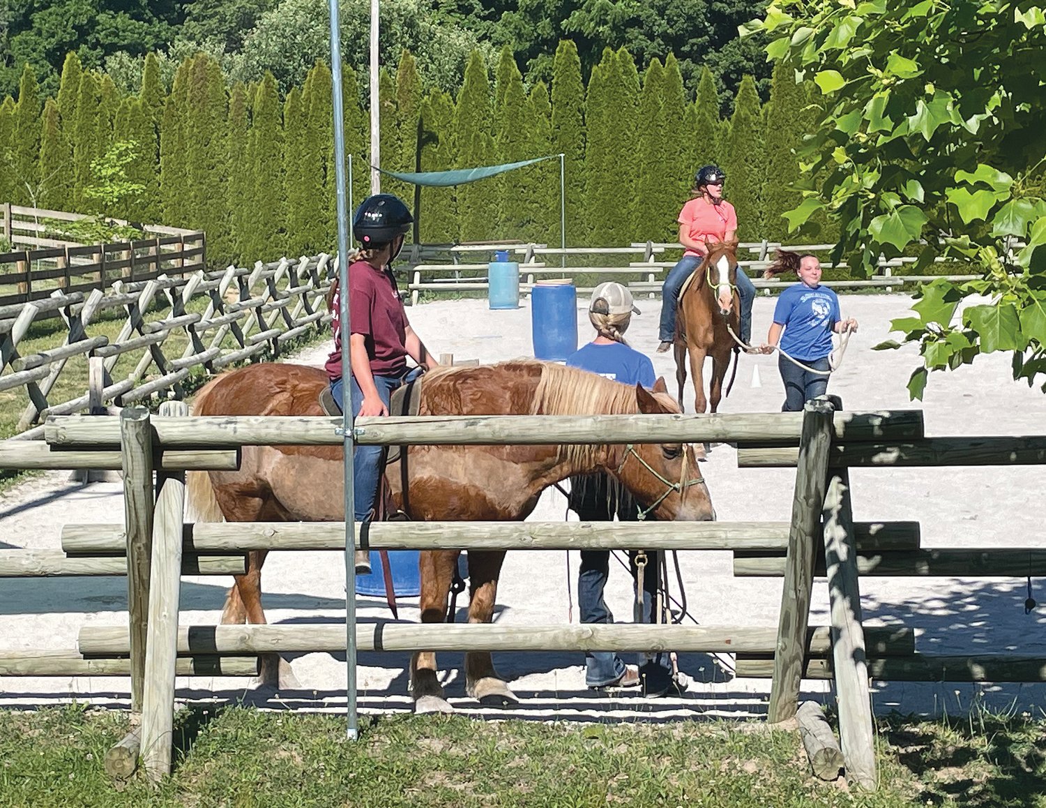Participants in the Harmony Project ride horses at the Achaius Ranch in Ladoga.