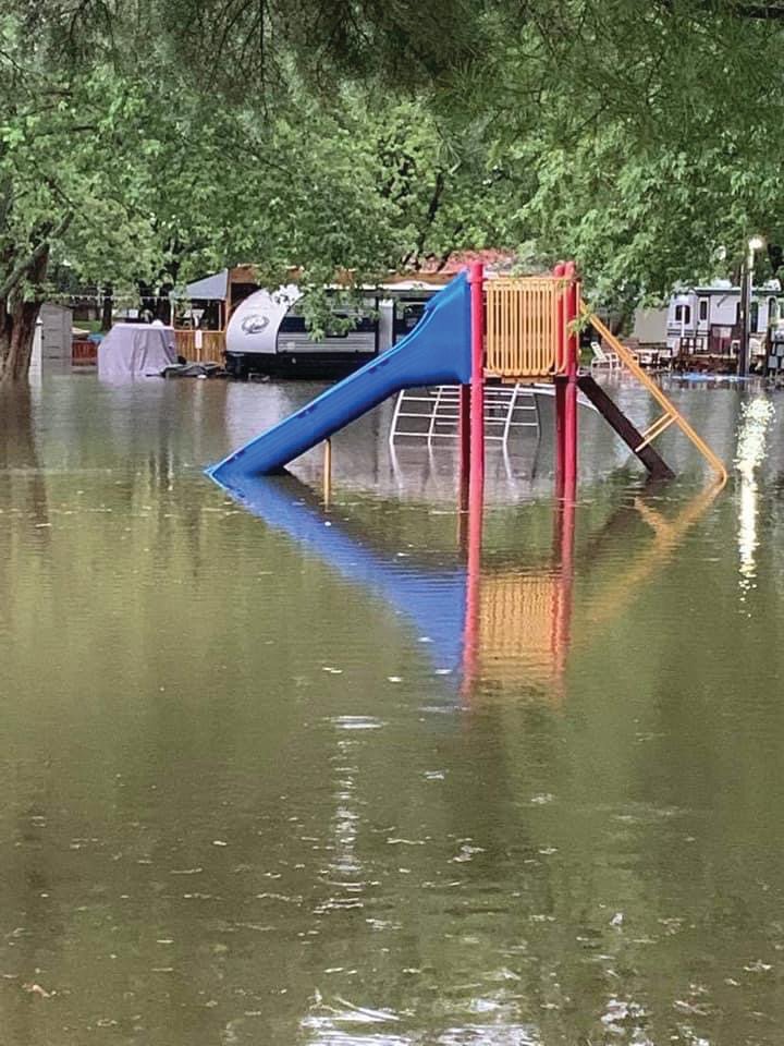 A playset sits in floodwaters Thursday at Sugar Mill Lake and Campground. The campground’s owners urged people to stay away as campers already on site assessed the damage to their sites.