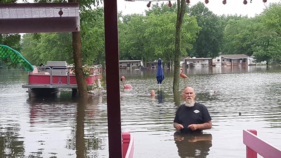 A man stands in floodwaters Thursday at Sugar Mill Lake & Campground. Heavy rains flooded the campground and closed roads in Fountain County.