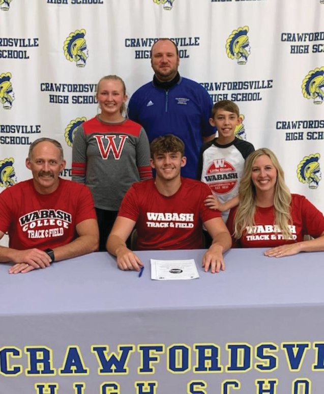 Crawfordsville’s Nate Schroeter is joined by his parents Matt and Andrea Schroeter, sister Alayna and brother Grant, with Crawfordsville track and field coach Sean Gerold in celebrating his commitment to Wabash College this spring.
