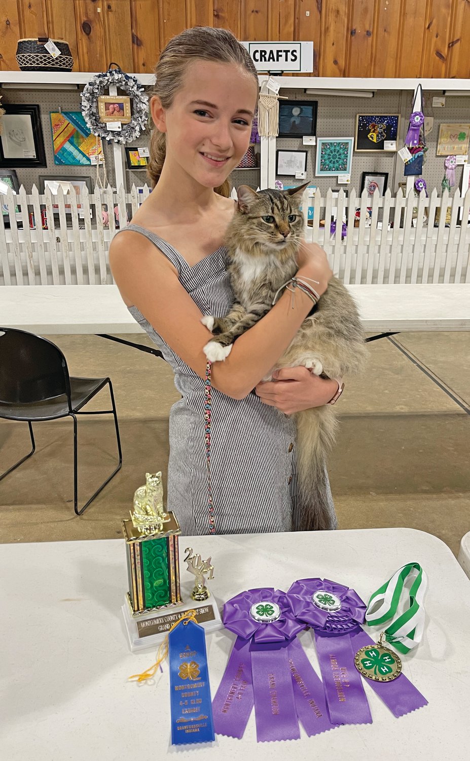 Evelyn Zachary stands with her grand champion cat, Maryanne, following the 4-H cat show at the Montgomery County Fairgrounds.