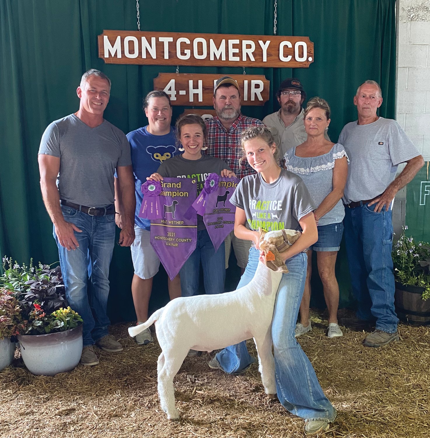 Bailey Barker stands with her grand champion meat wether at the Montgomery County 4-H Fair.