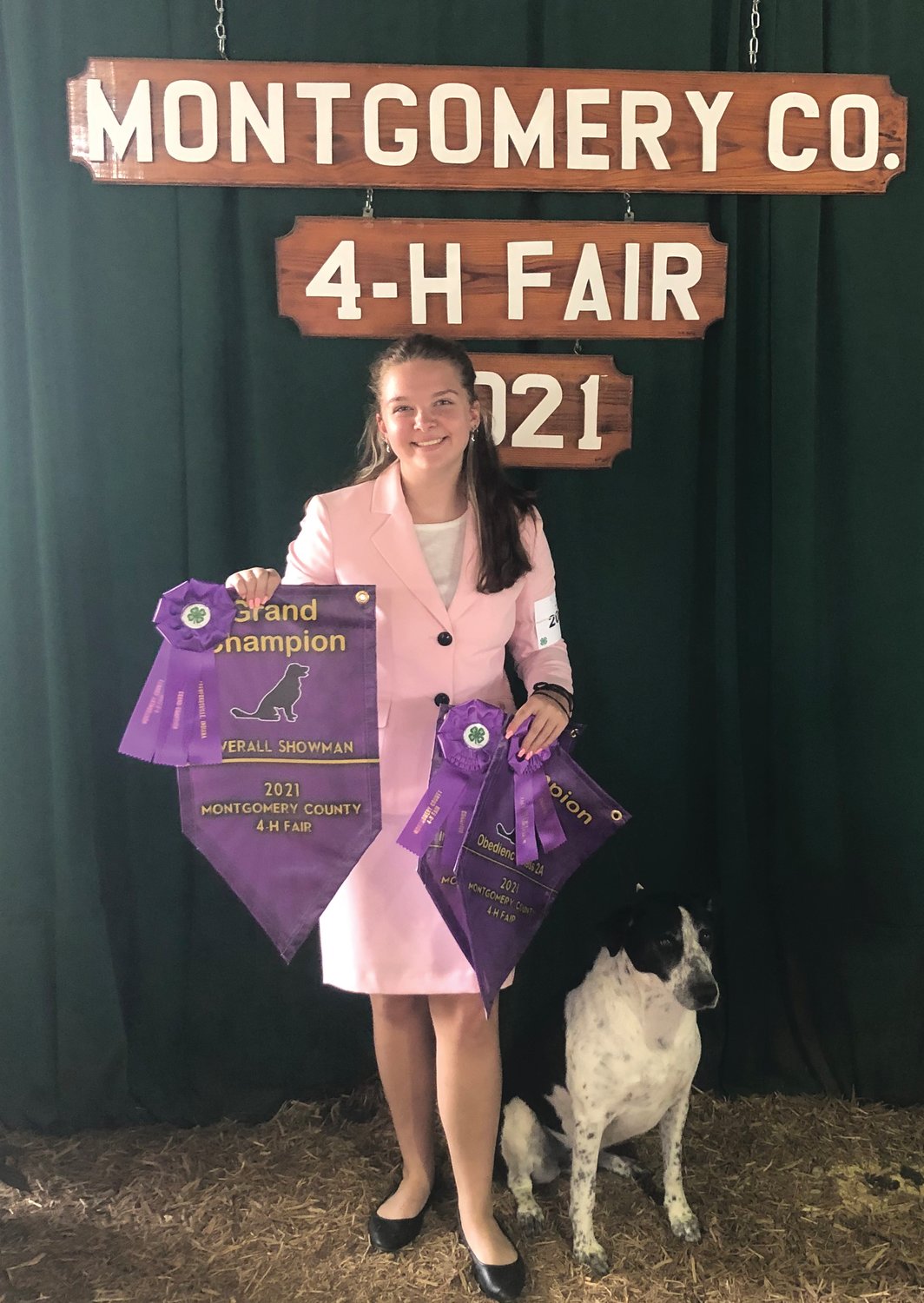 Mallory Leach stands with her border collie-lab mix Gracie after winning grand champion for overall showman in the dog show at the Montgomery County 4-H Fair.