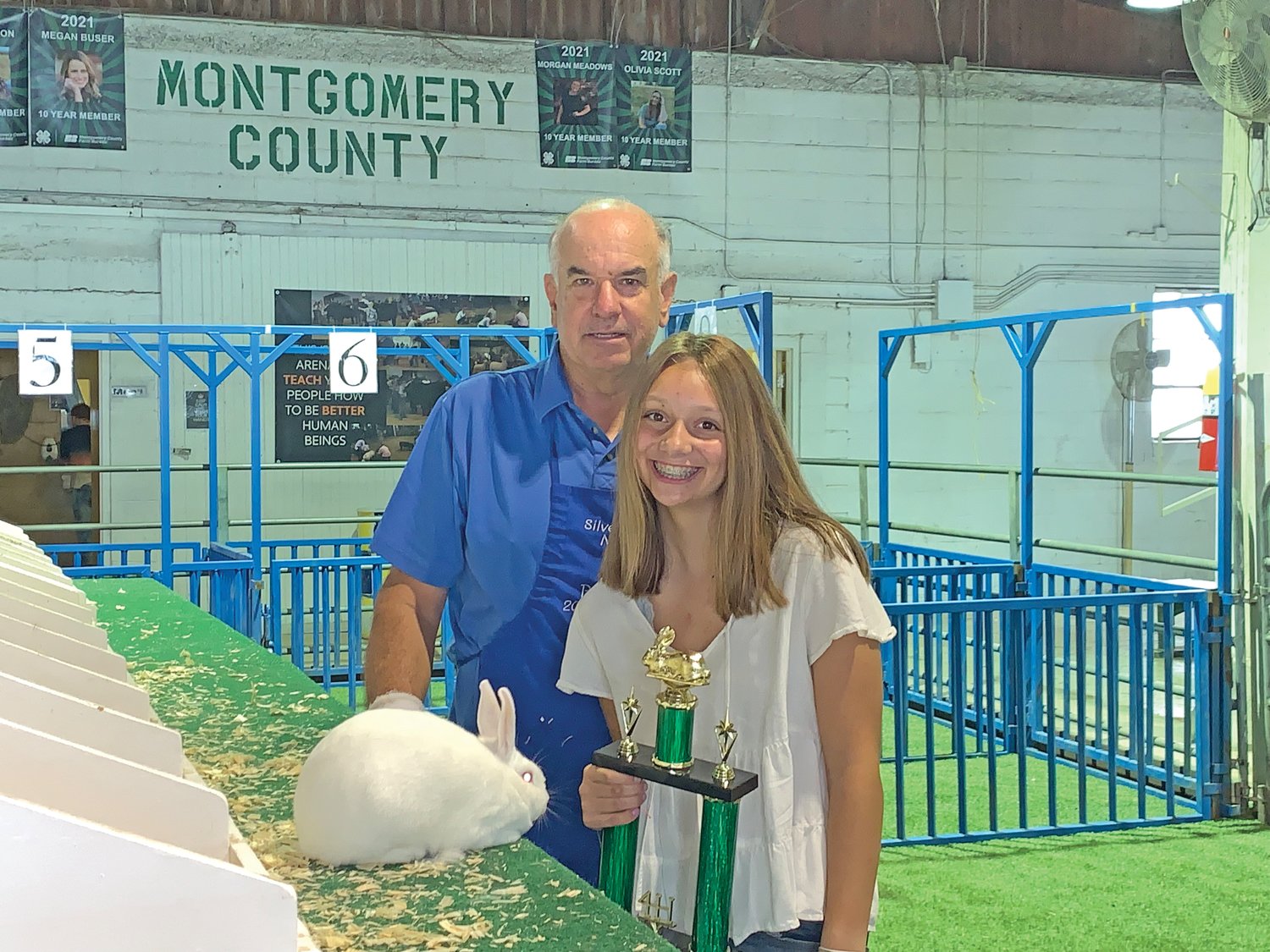Peyton Page stands with her grand champion rabbit following the 4-H rabbit show at the Montgomery County Fairgrounds.