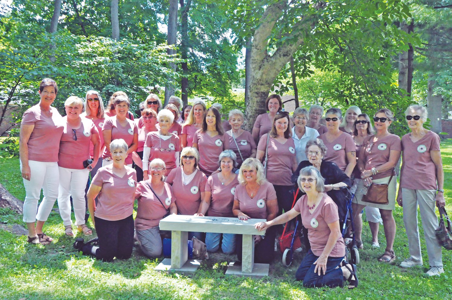 Flower Lovers Garden Club members pose Wednesday around a bench dedicated to the City of Crawfordsville in honor of the club’s 100th anniversary on the grounds of the General Lew Wallace Study & Museum.