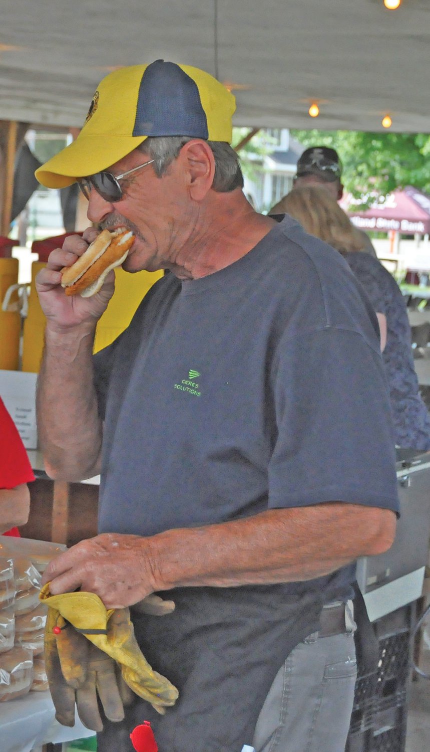 EJ Dixon taste tests a fish sandwich at the Ladoga Lions Club Fish Fry on Friday. The 81st annual event featured live music, fireworks, carnival rides and vendor booths.