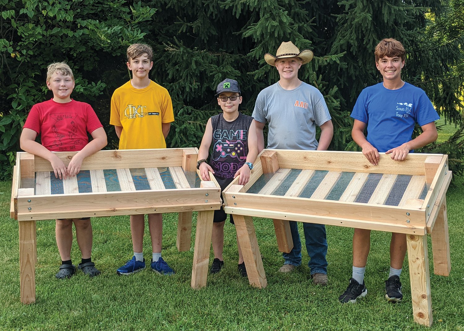 Boy Scouts Logan Spears, from left, Lucas Spears, Eric Wethington, Trae Hunt, and Dustin Pensworth stand with raised garden beds their troop donated to Ben Hur Health & Rehabilitation.