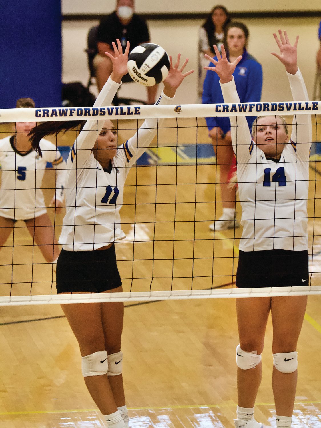 Crawfordsville senior Alyx Bannon skies for a block on Tuesday night against Crawfordsville.