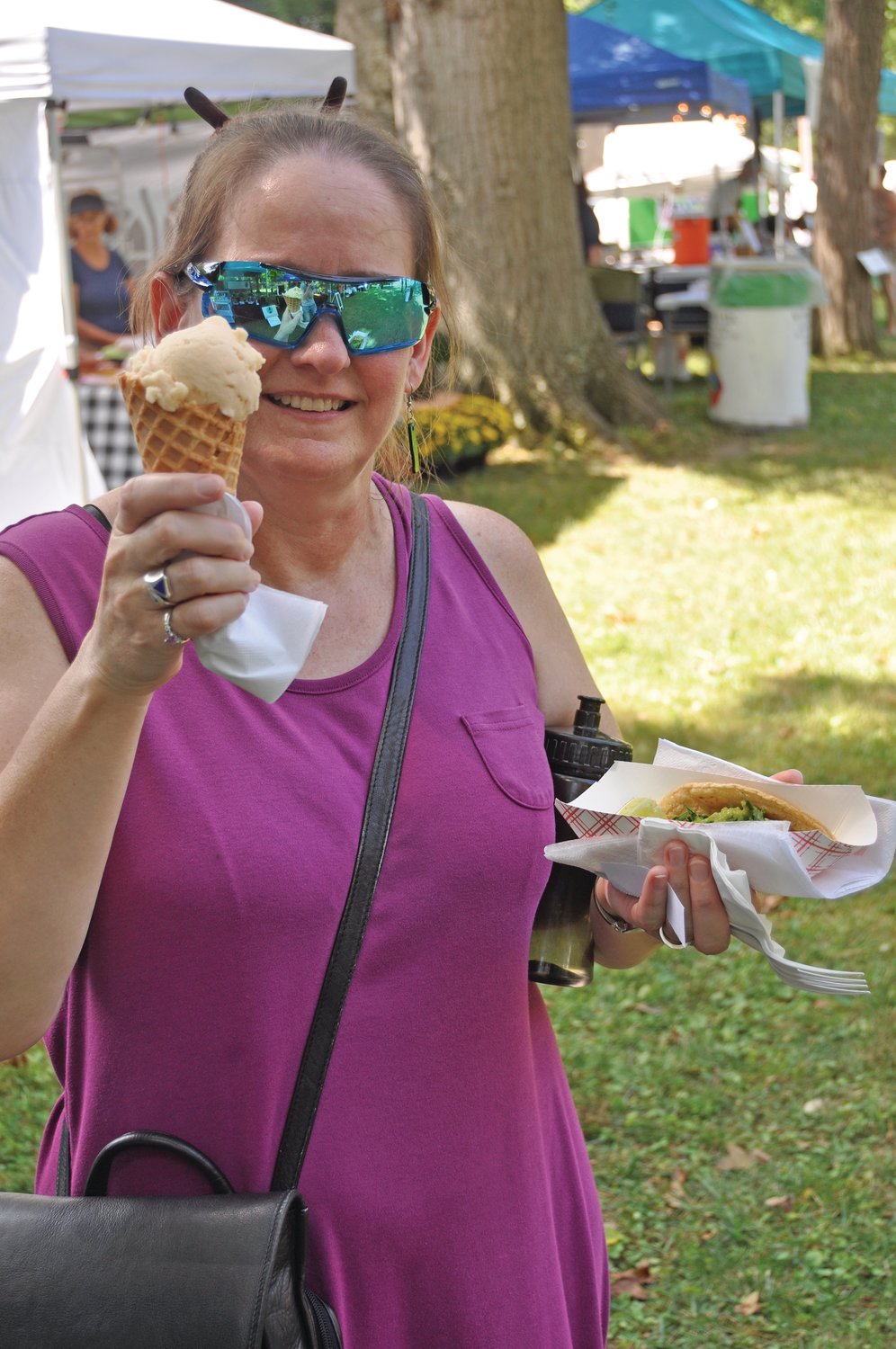 Karen Gunther shows off the food she purchased at the Taste of Montgomery County on the grounds of the Lew Wallace Study & Museum on Saturday.