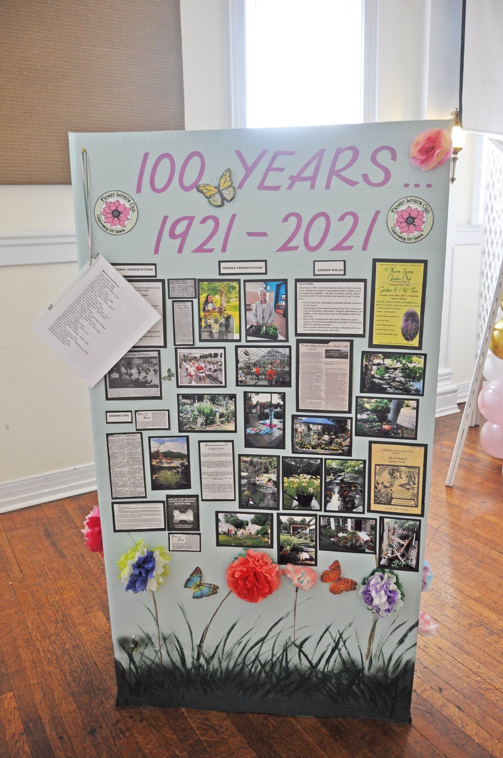 A historical display shows information about the Flower Lovers Garden Club. The display can be viewed at Fusion 54 and the Carnegie Museum of Montgomery County.