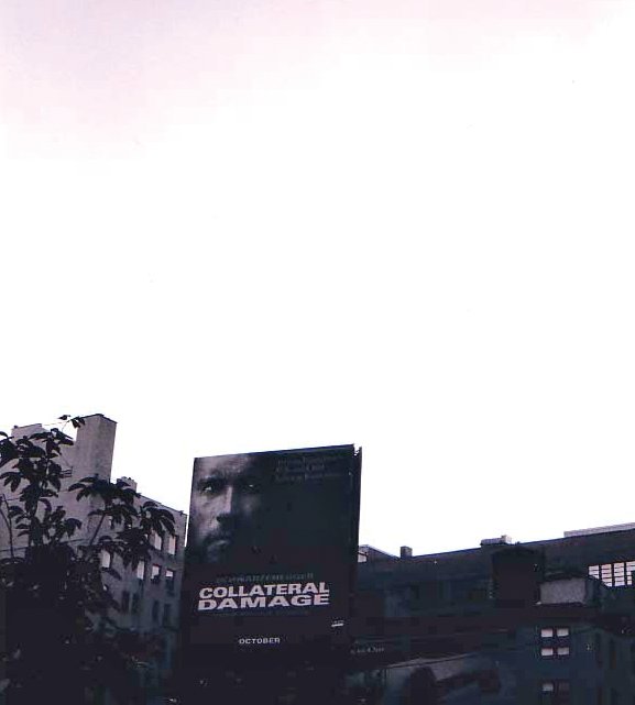 A billboard advertises the film