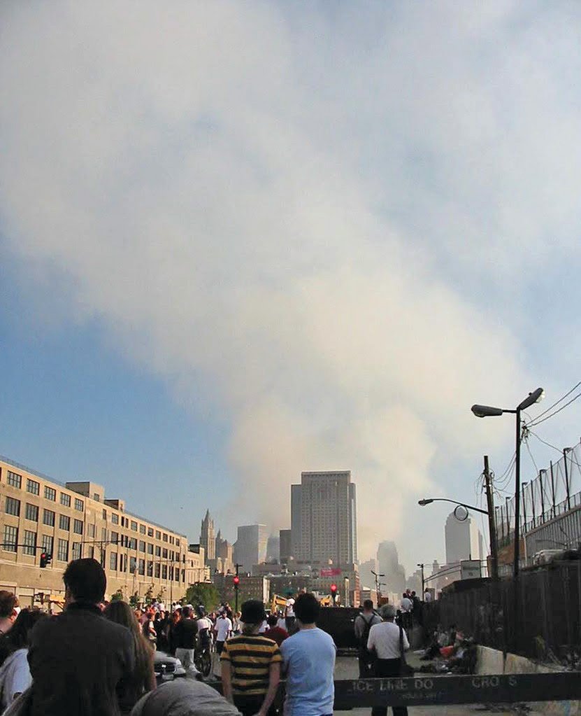 People look at the smoke rising from the rubble of the World Trade Center after the Sept. 11, 2001 attacks.