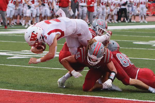 Wabash junior quarterback Liam Thompson accounted for four touchdowns, including this rushing touchdown in the first quarter.