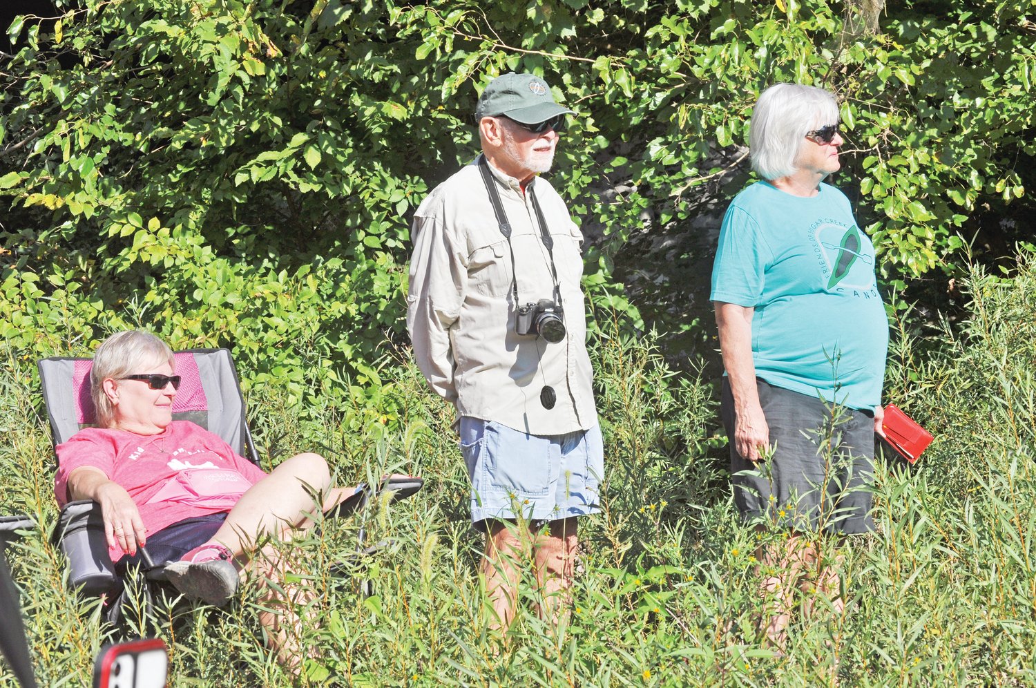 Austin Brooks, center, past president of Friends of Sugar Creek, watches the demolition of the Sugar Creek lowhead dam with FCS member Sue Fain, left, and executive director Cindy Woodall on Tuesday.
