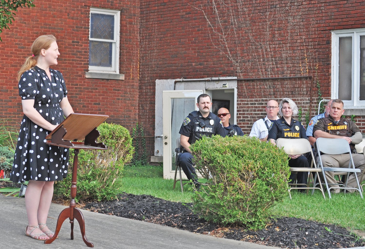 Christina Sharp delivers remarks as police and fire personnel listen at the annual 9/11 memorial ceremony at Pentecostals of Crawfordsville on Saturday.