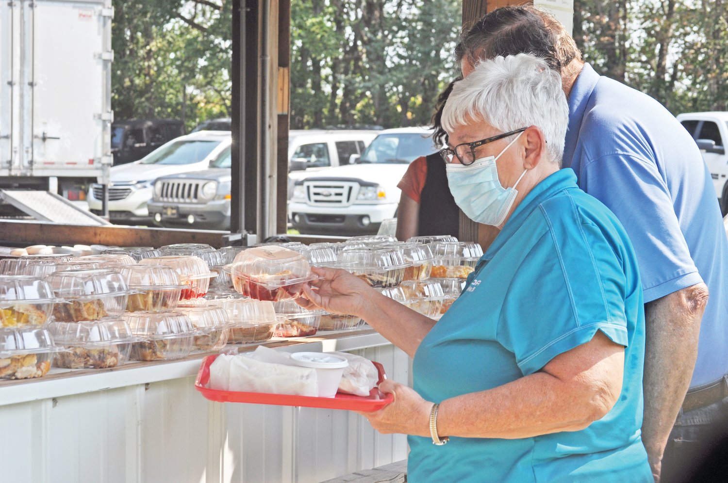 Teresa Largent selects a dessert as her husband Pete looks at the selection at the Waynetown Fish Fry on Saturday.