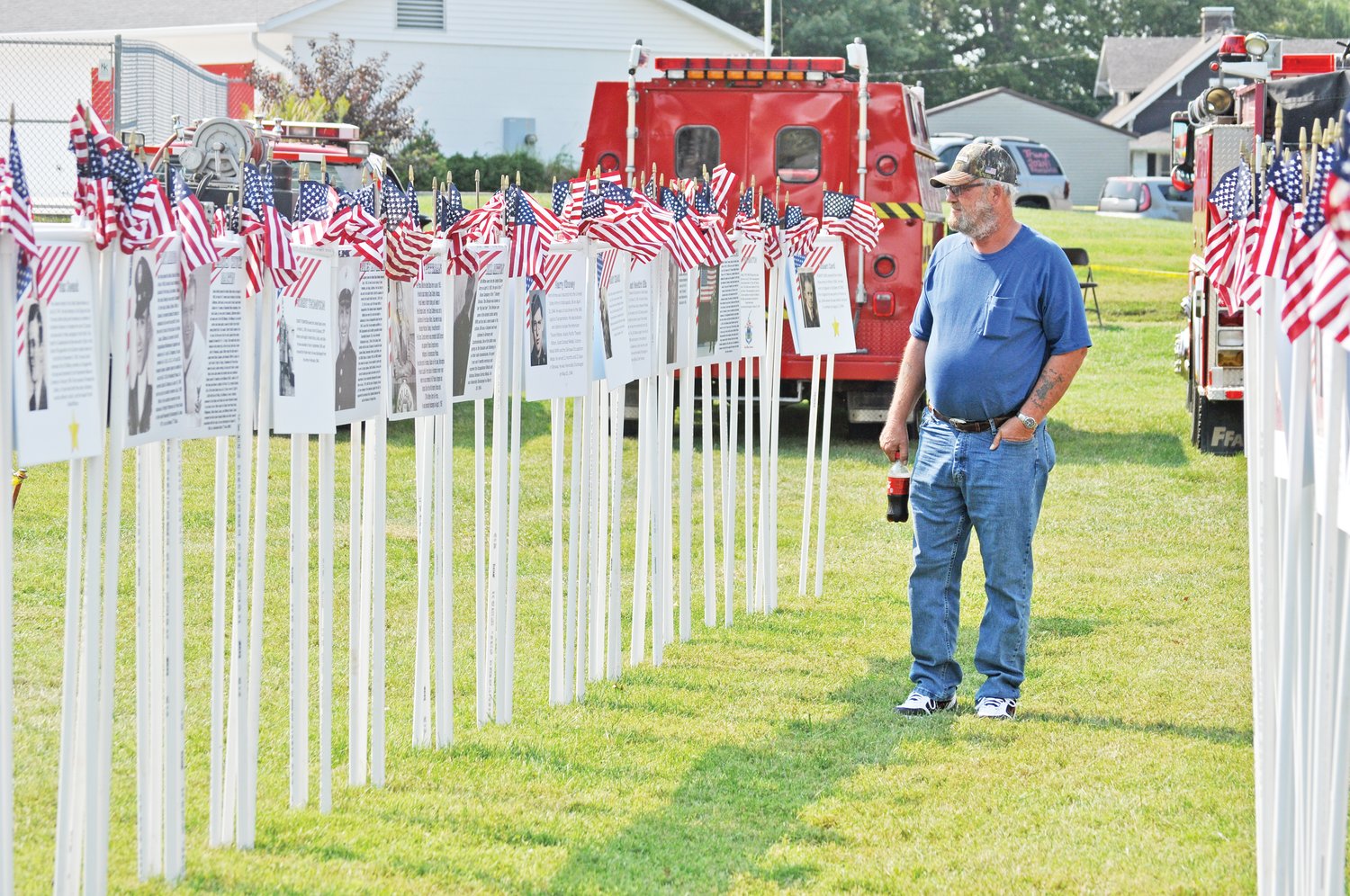 Monty Mitchell looks at a display honoring local veterans at the Waynetown Fish Fry on Saturday.