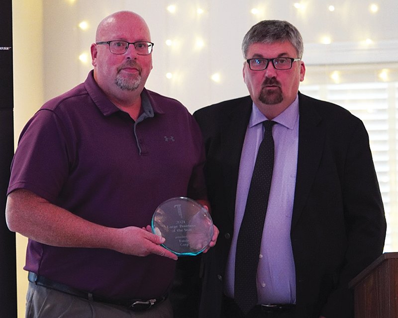 Phil Goode, right, representing CEL&P, the 2020 Large Business of the Year, presents the award to Banjo Corp.