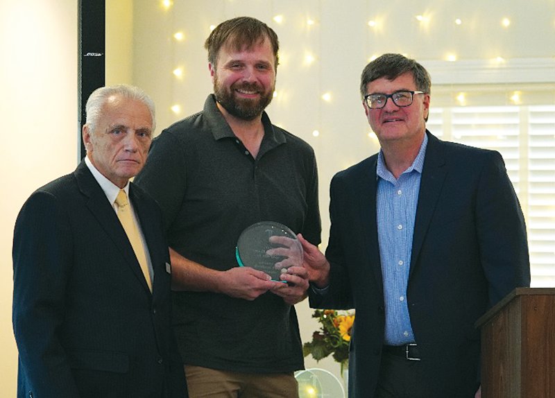 David Long, left, and Dave Peach of WCDQ Radio, 2020 Small Business of the Year, present the 2021 Small Business of the Year award to Brothers Pizza Co., represented by Michael Lowe.