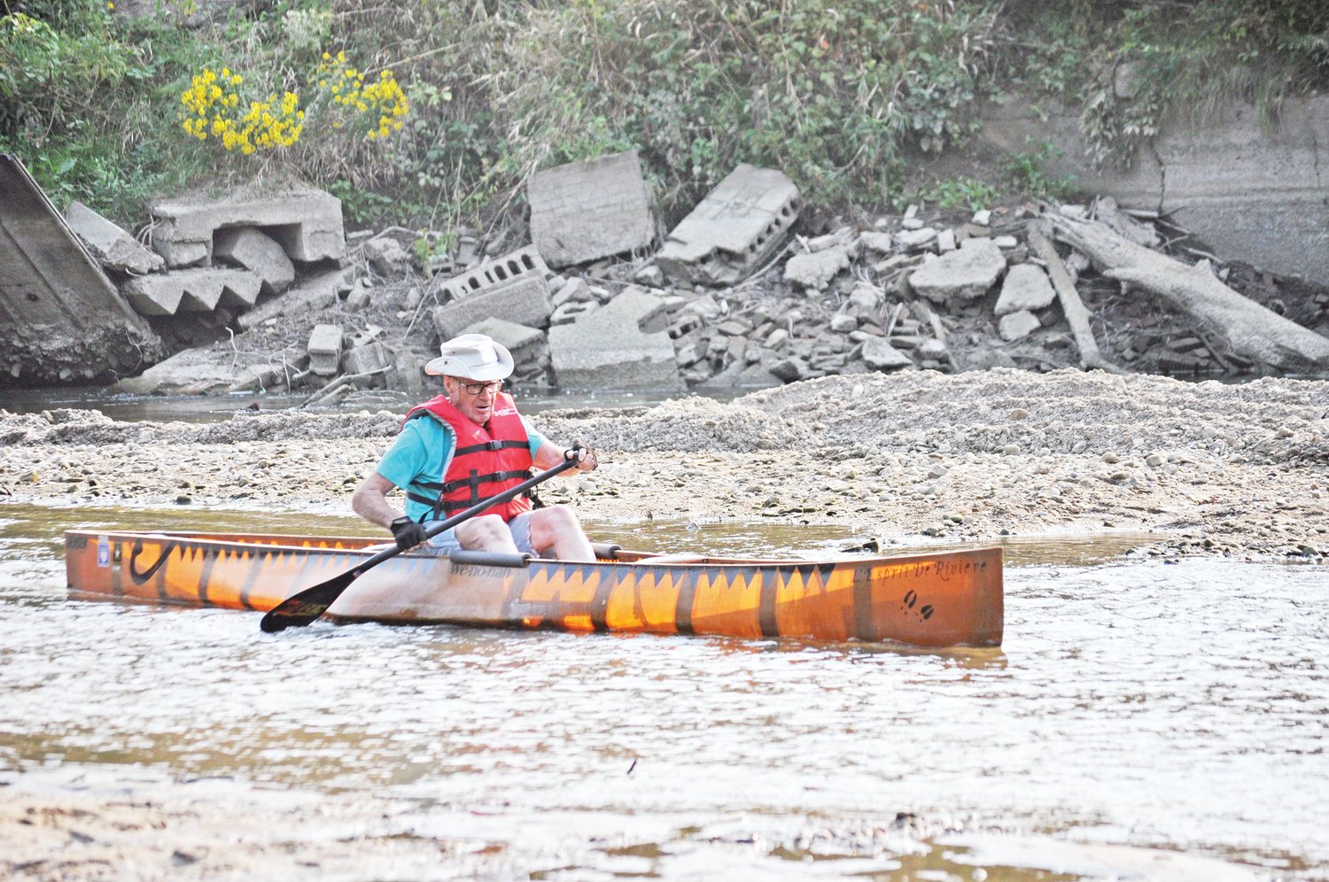 Bob Stwalley, 90, paddles through the old lowhead dam site on Sugar Creek. The dam was removed last week, and Stwalley said there was about only about 4 inches of water in that part of the creek. In a letter submitted to the Journal Review, Stwalley wrote: “I wish to thank all involved in the removal of the last dam on Sugar Creek. Mayor Todd Barton and his administration, the Friends of Sugar Creek, Dr. Jerry Sweeten and his staff and the heavy equipment operators of Walden’s. From start to finish, four days. Fantastic. I dedicate this paddle through the old dam site to three men and one woman who are no longer with us: Roger Beach, Don Bickel, Dr. Lewis Runnels and Patt Oakley. Also to Bob Demoret, my part-time paddling partner and all the USA paddlers. May this beautiful river now forever flow free.”