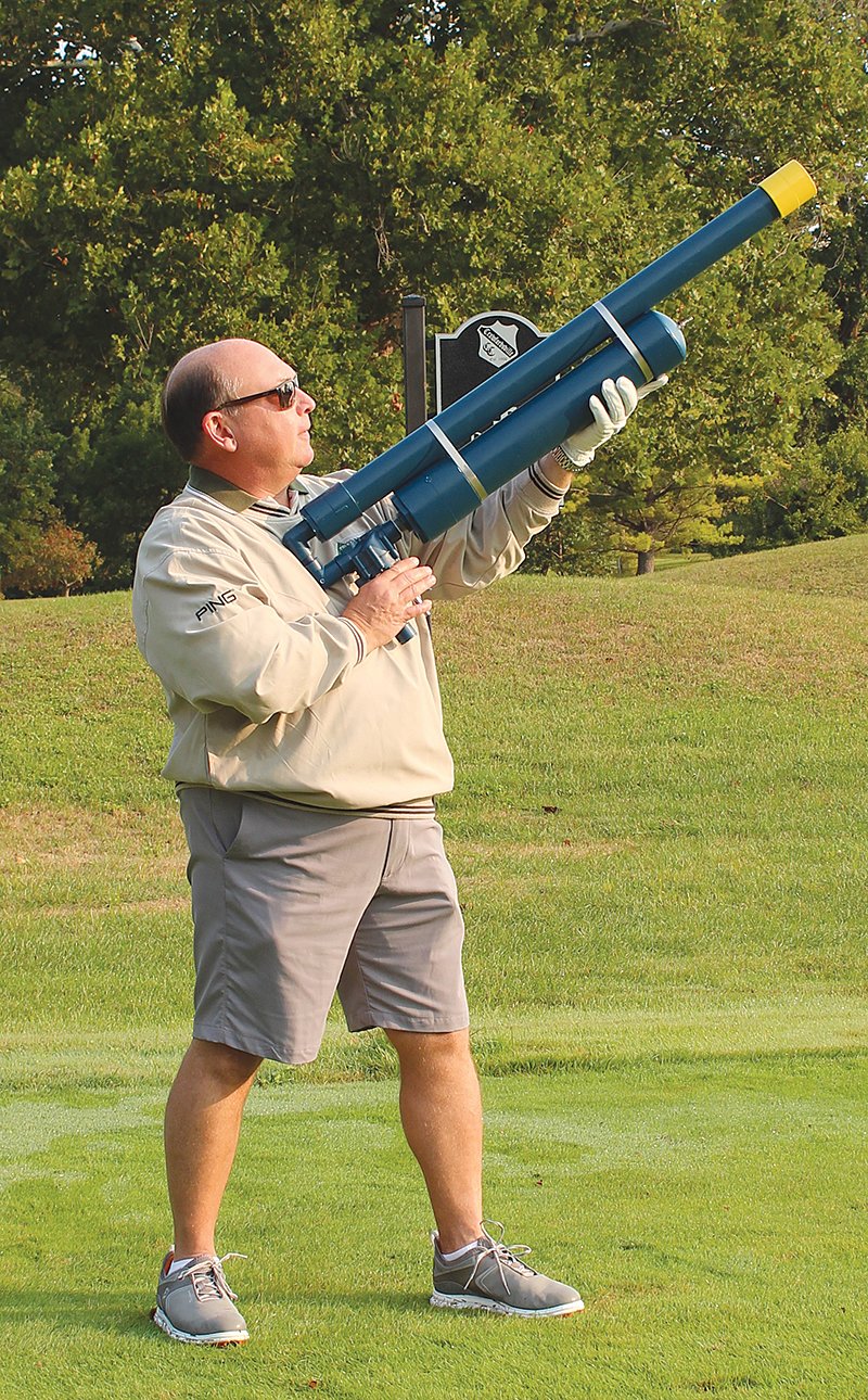 Steven McLaughlin, vice president at Tri-County Bank & Trust, uses the golf cannon for his drive off hole 4.