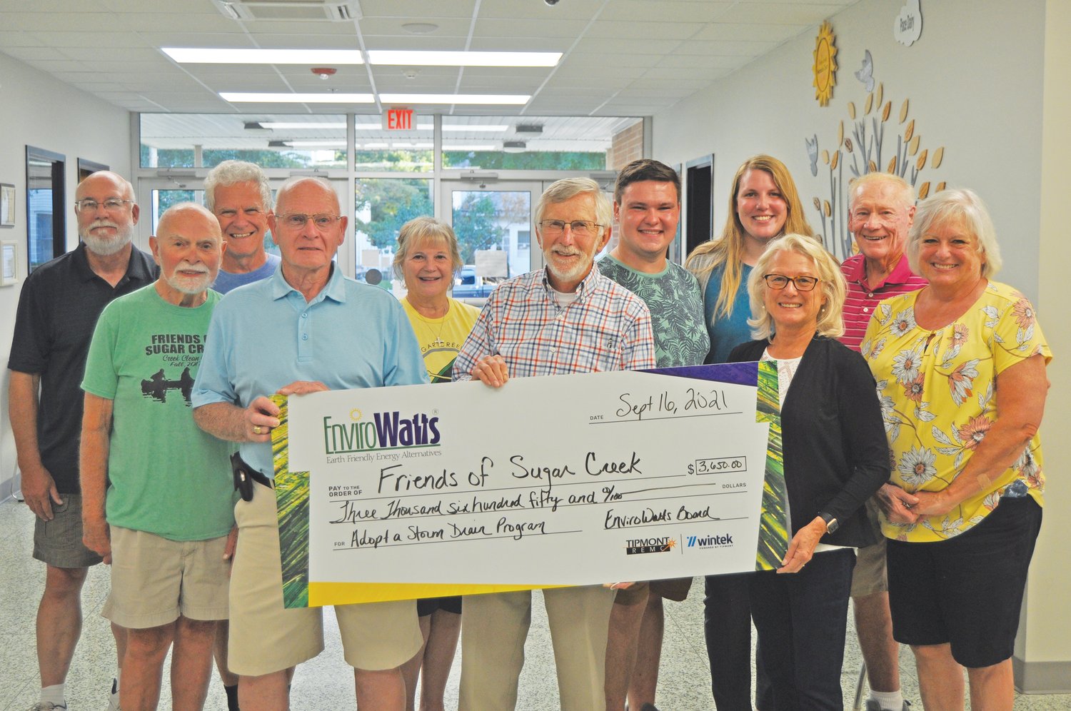 Friends of Sugar Creek members accept a grant from the Tipmont REMC EnviroWatts program to support promotion of the Adopt-A-Drain program on Thursday.