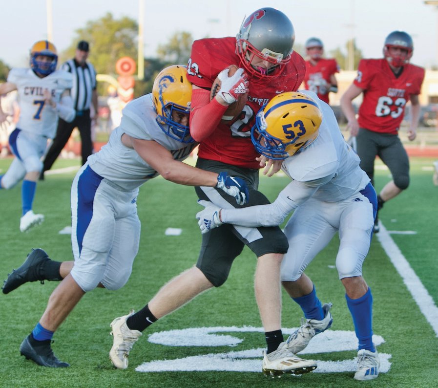 A pair of Crawfordsville defenders try and bring down Southmont's Carson Chadd.